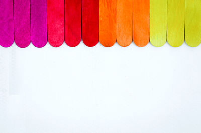 Close-up of multi colored pencils over white background