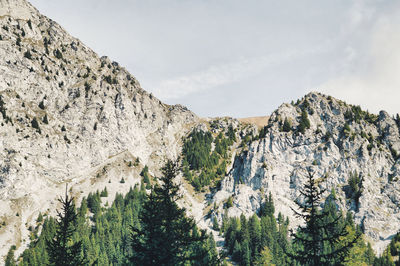 Low angle view of rocky mountains against sky