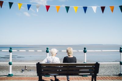 Rear view of senior women sitting on bench