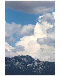 Scenic view of mountains against cloudy sky