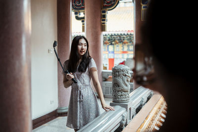 Woman standing against wall