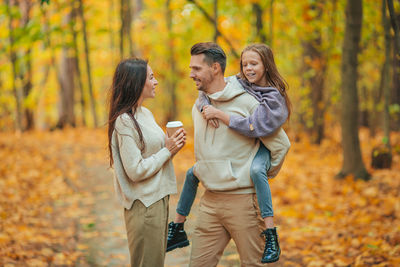 Couple kissing in forest during autumn