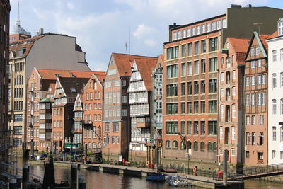 Buildings by canal in city