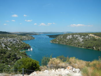 High angle view of trees on landscape against blue sky