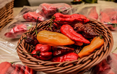 Close-up of chili peppers in wicker basket on table