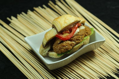 High angle view of sandwich served over black background