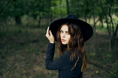 Portrait of young woman standing outdoors