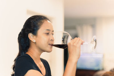 Portrait of a woman drinking red wine