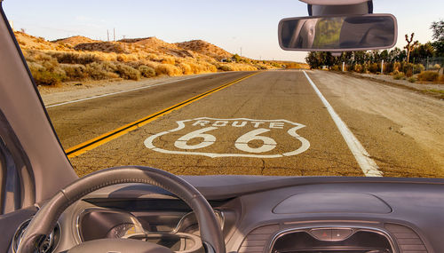 Road sign seen through car windshield