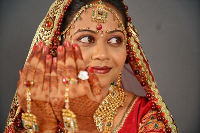 Bride with henna tattoo over gray background