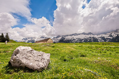 Scenic view of rocks on field against sky