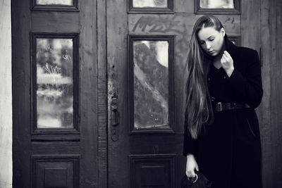 Woman looking through window