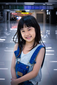 Portrait of smiling girl standing at night