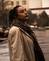 Portrait of young woman standing outdoors