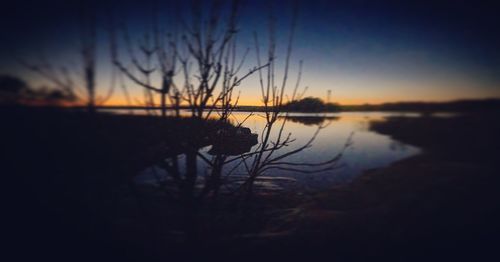 Scenic view of lake against sky at sunset