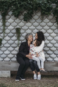 Portrait of multigenerational women sitting and smiling outside