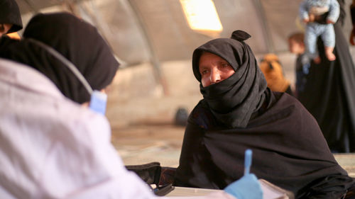 An elderly woman receives medical care at a makeshift medical clinic inside a syrian refugee camp.