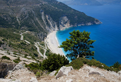 High angle view of sea by mountain against sky