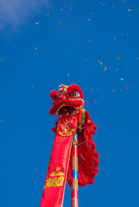 Low angle view of chinese dragon against clear blue sky