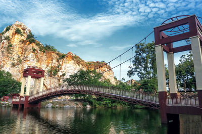 Arch bridge over river against sky