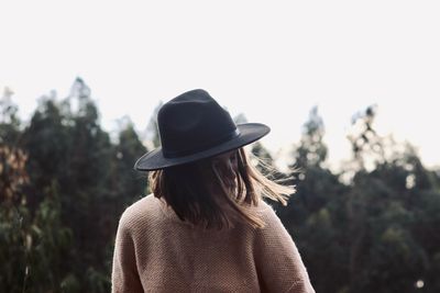 Rear view of woman wearing hat against sky