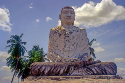 Statue of buddha against sky