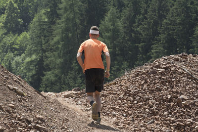 Rear view of man standing in forest