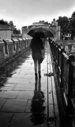 Full length of woman standing on railing