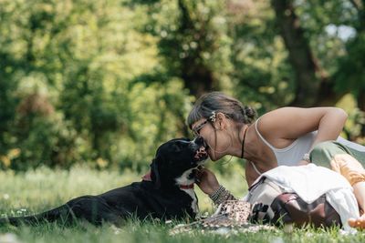 Rear view of woman with dog against plants