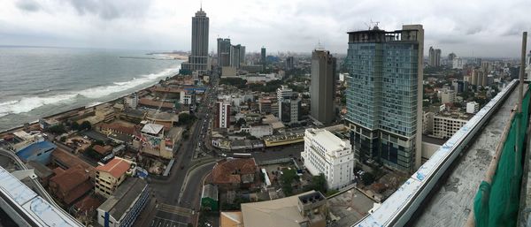 High angle view of cityscape against cloudy sky