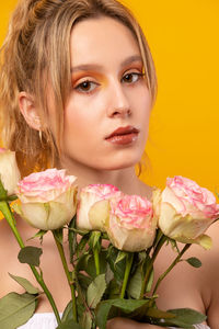 Close-up portrait of woman with pink flower