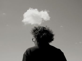 Rear view of man against blue sky