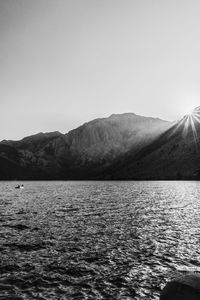 Scenic view of lake and mountains against clear sky