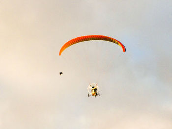 Person paragliding against sky