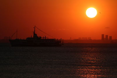 Scenic view of sea against orange sky