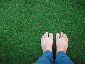 Low section of person standing on field