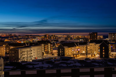 Buildings in city against sky during sunset