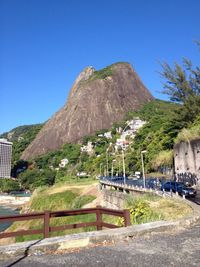 View of town on mountain against blue sky