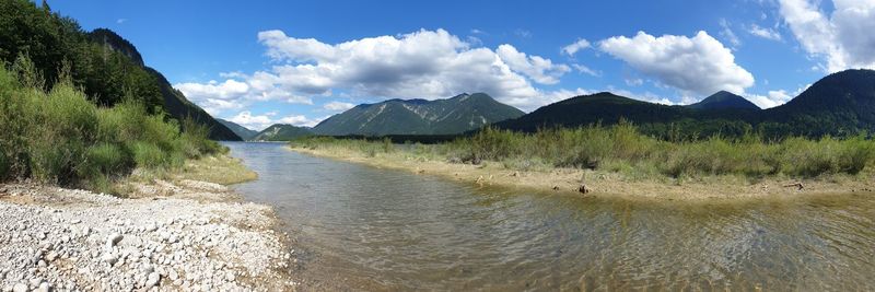 Panoramic view of river amidst mountains against sky