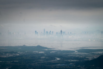 High angle view of buildings in city against sky