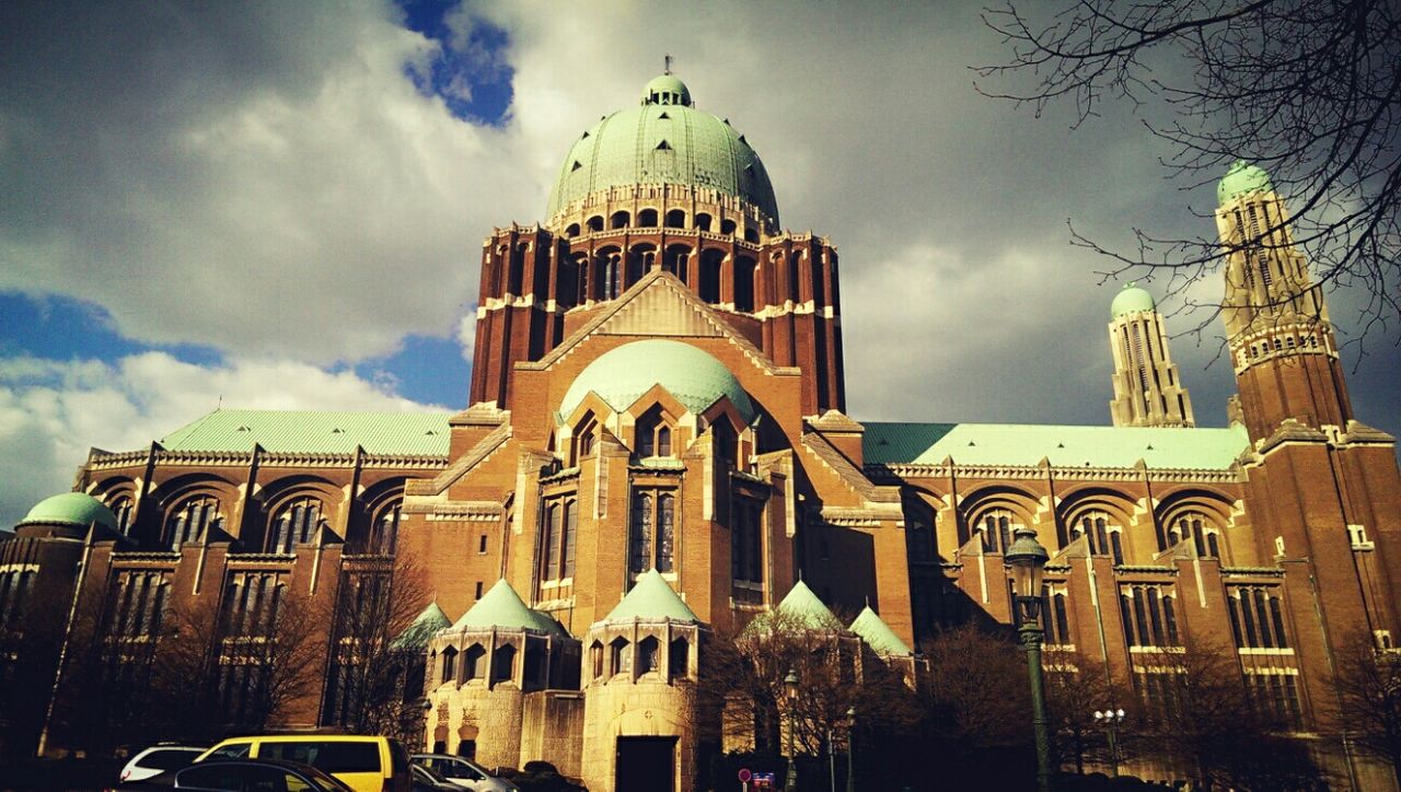 architecture, building exterior, religion, built structure, place of worship, church, spirituality, sky, cathedral, low angle view, cloud - sky, facade, dome, cloudy, travel destinations, cloud, city, history