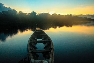 Scenic view of river against sky at sunset