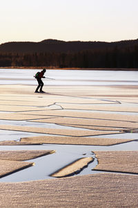 Woman ice-skating, ice floe on foreground