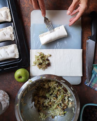 High angle view of person preparing food on table