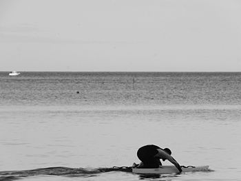 Woman on beach against clear sky