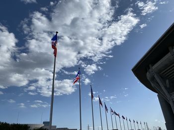 Low angle view of flags against sky