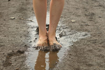 Young girls's muddy feet. selective focus.