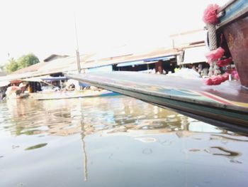 Close-up of boats moored in sea against clear sky