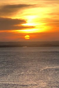 Scenic view of sea against romantic sky at sunset