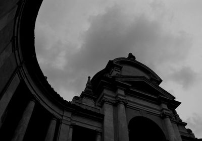Low angle view of building against cloudy sky